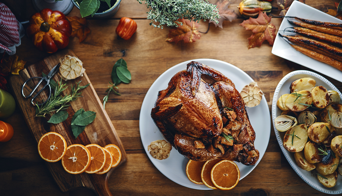 overhead display of roasted turkey and trimmings being prepared for a traditional holiday meal