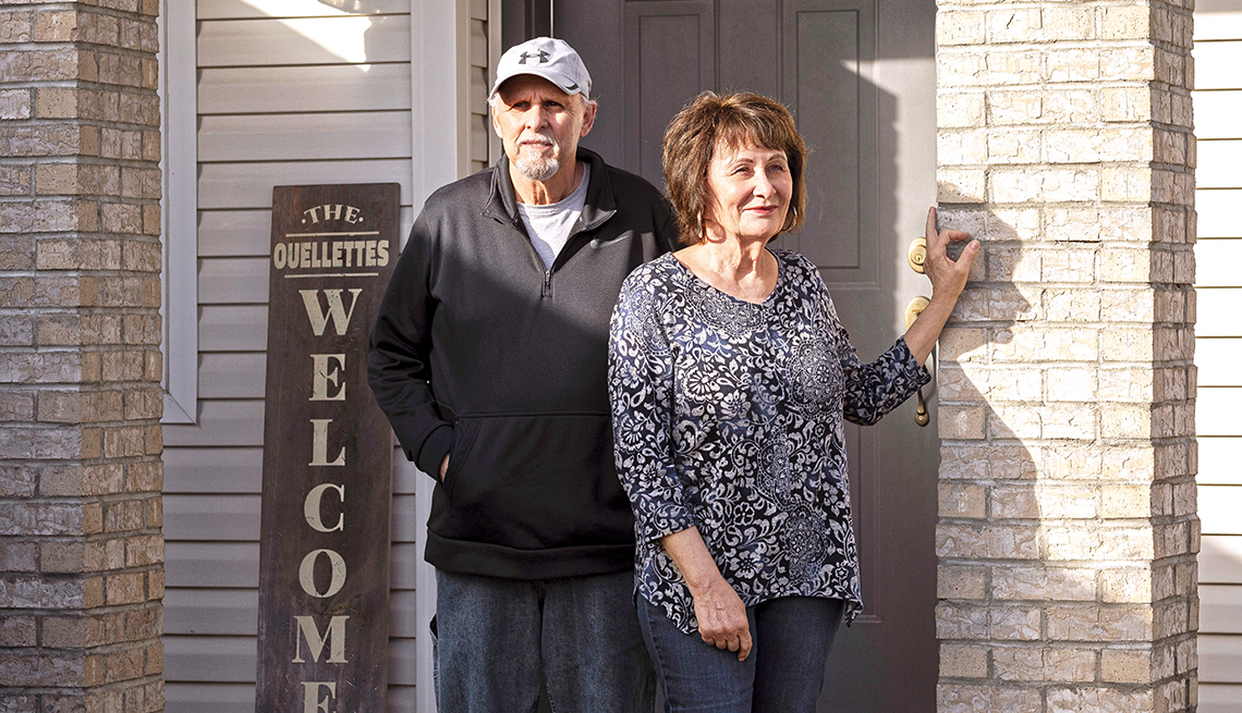 bob and chris ouellette in front of their home