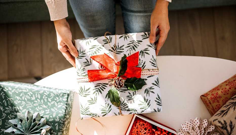 a woman holding a wrapped holiday gift