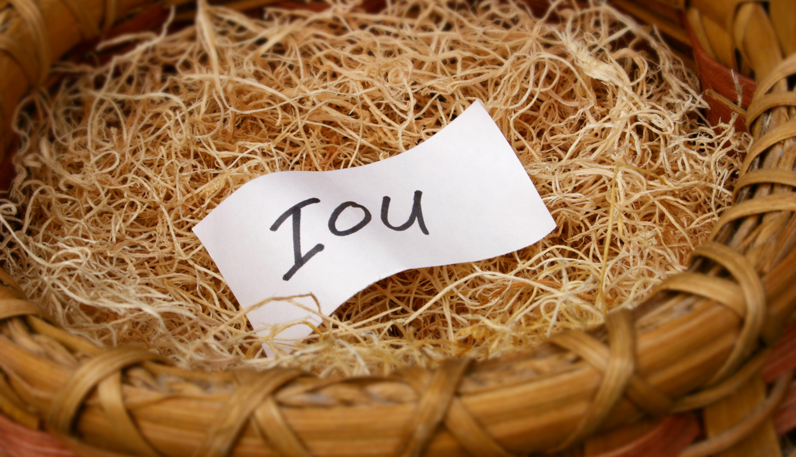a handwritten "IOU" slip inside an empty bird's nest 
