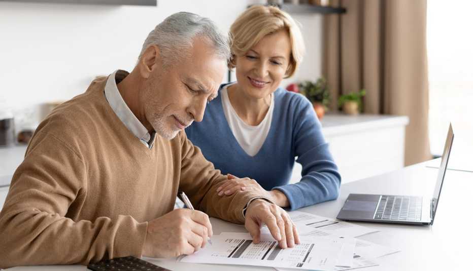 a man and woman looking at papers