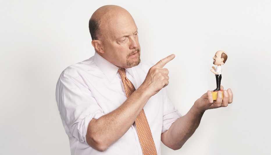 jim cramer pointing at a bobble head of himself