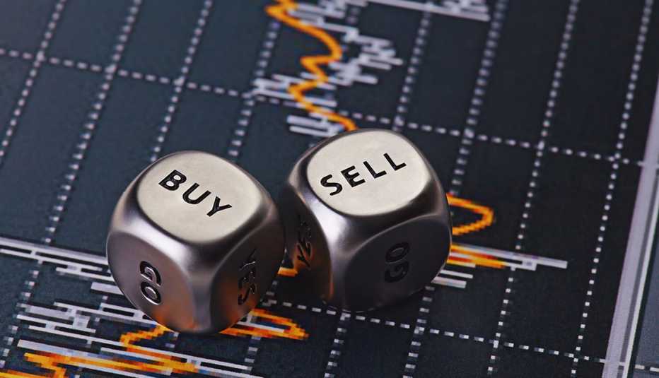 silver dice cubes with the words SELL BUY on top of stock chart background