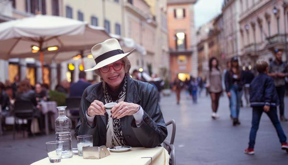 Jane Bryant Quinn sitting at an outdoor cafe in Rome, Italy