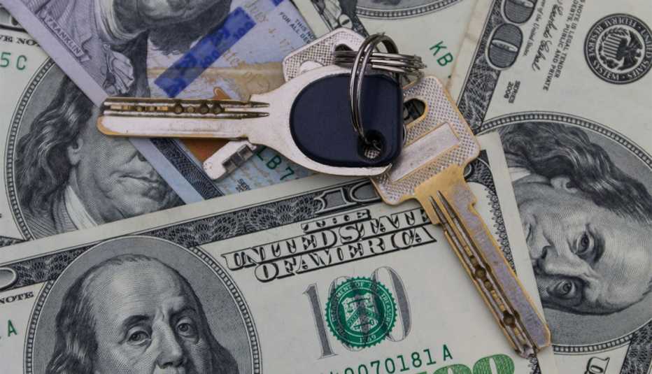 house keys on top of hundred dollar bills
