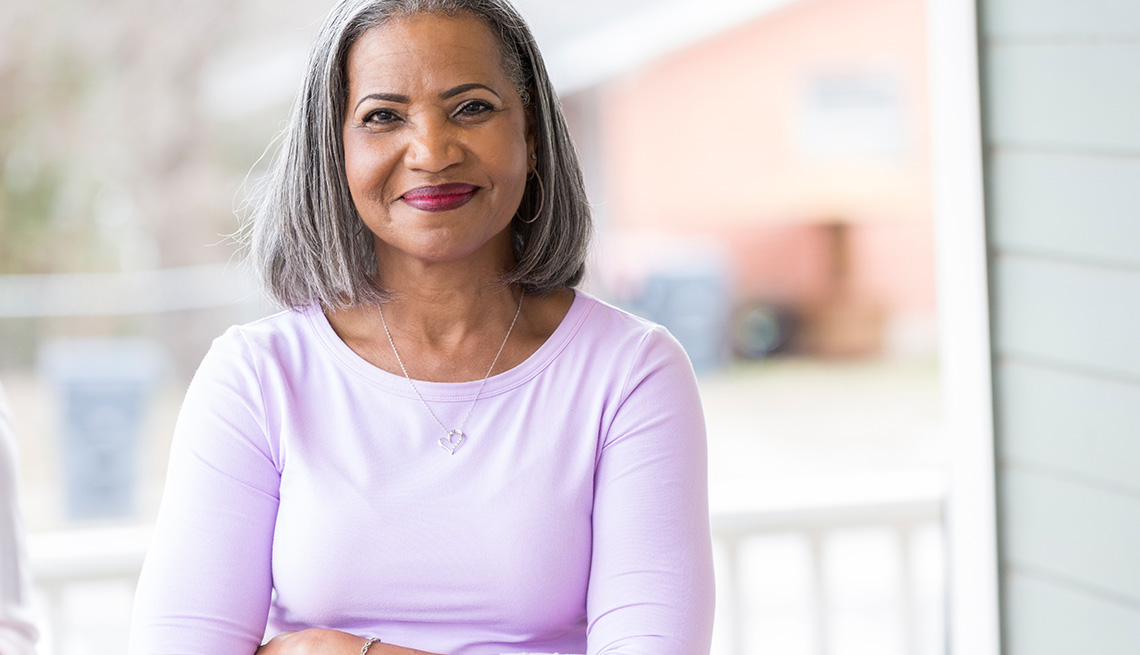 Mature woman standing on porch