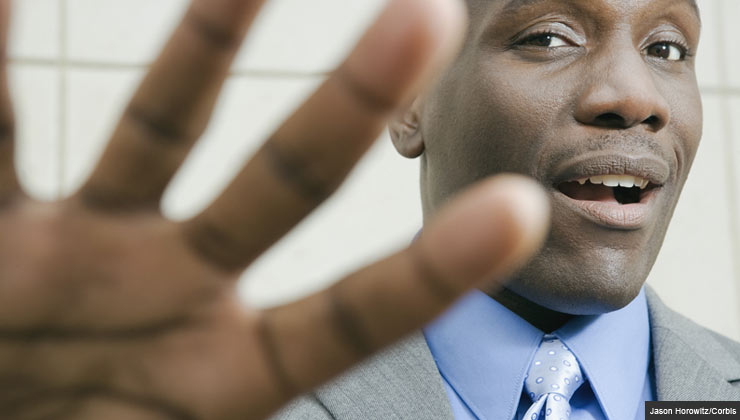 Businessman Raising His Hand to Reject a Bequest