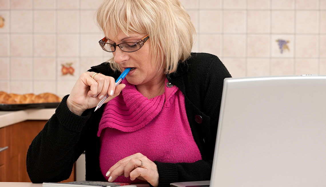 woman with pen and calculator