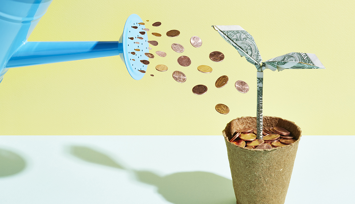 watering investment plant with watering can of coins
