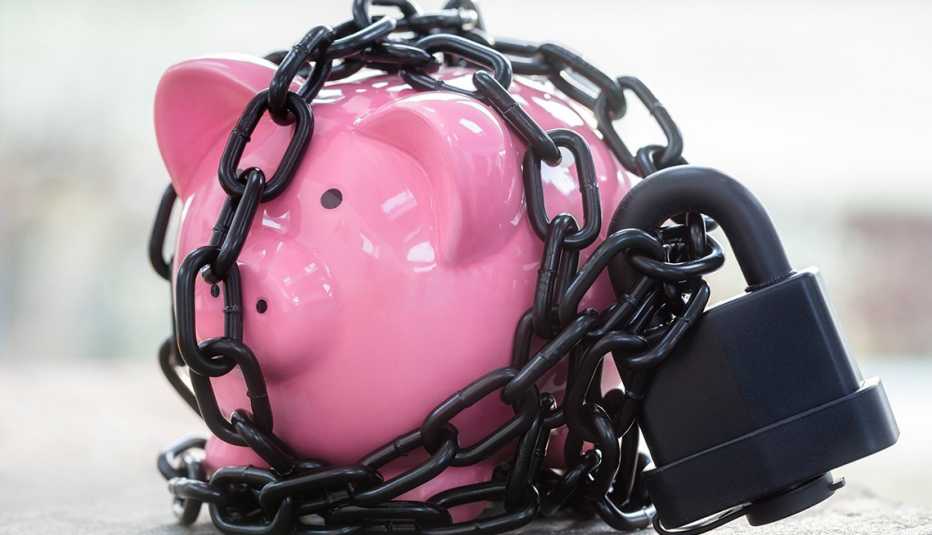 a pink piggy bank is tightly locked up with a heavy padlock and chains a pink piggy bank is tightly locked up with a heavy padlock and chains