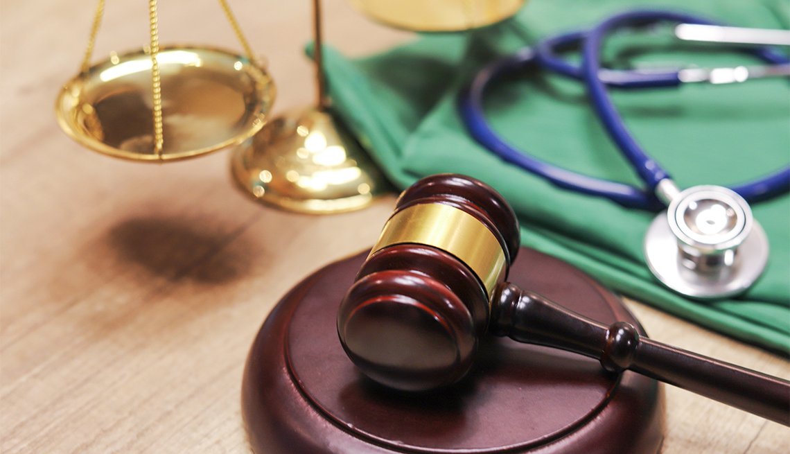  Gavel and justice scales with stethoscope in the background