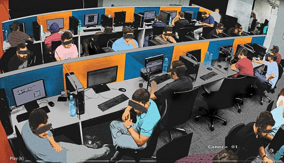 security camera still from a fraud factory office showing people working at cubicles with their faces obscured to hide their identity security camera still from a fraud factory office showing people working at cubicles with their faces obscured to hide their identity