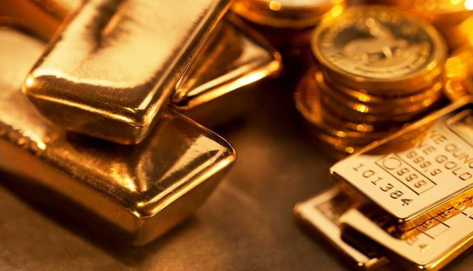 Close up image of assorted gold ingots and gold coins