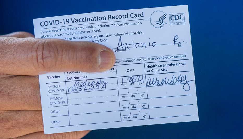 Former Los Angeles Mayor Antonio Villaraigosa holds his vaccination card after receiving his first shot