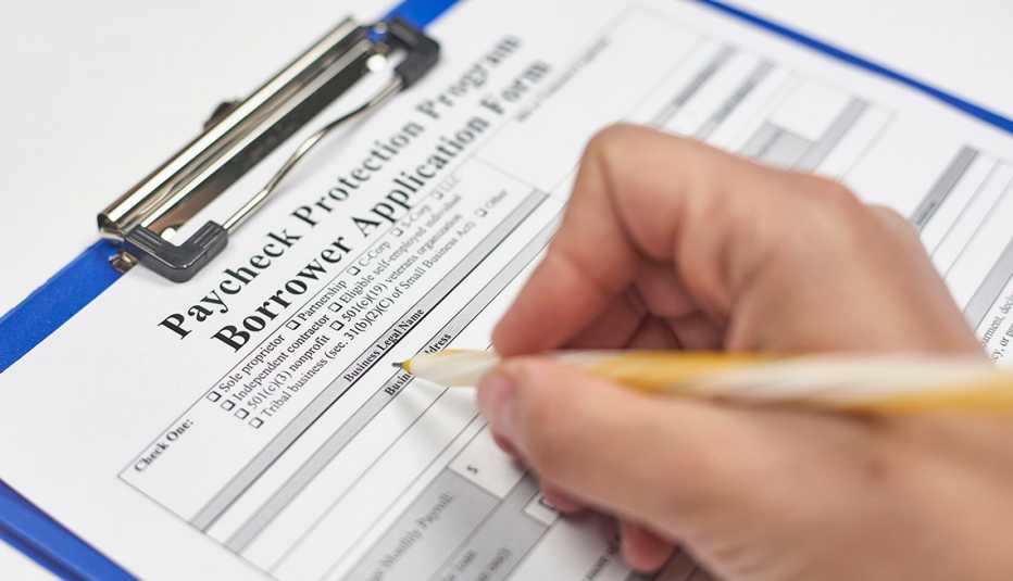 A person filling a Paycheck Protection Program loan application.