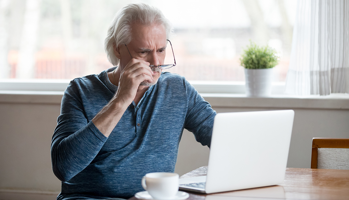 Man looking in disbelief at his computer