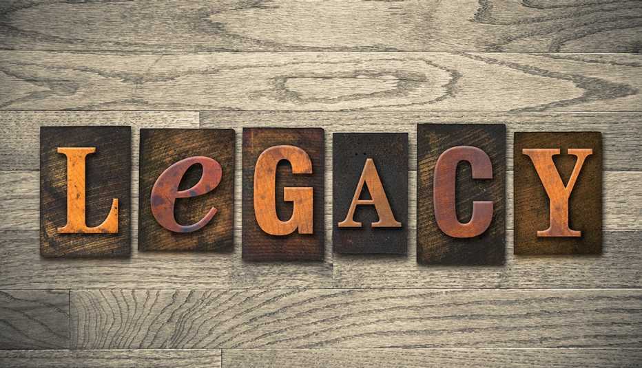 The word "LEGACY" written in wooden letters on a wood-grained background "LEGACY" is spelled out in wooden letters on a wood-grained background