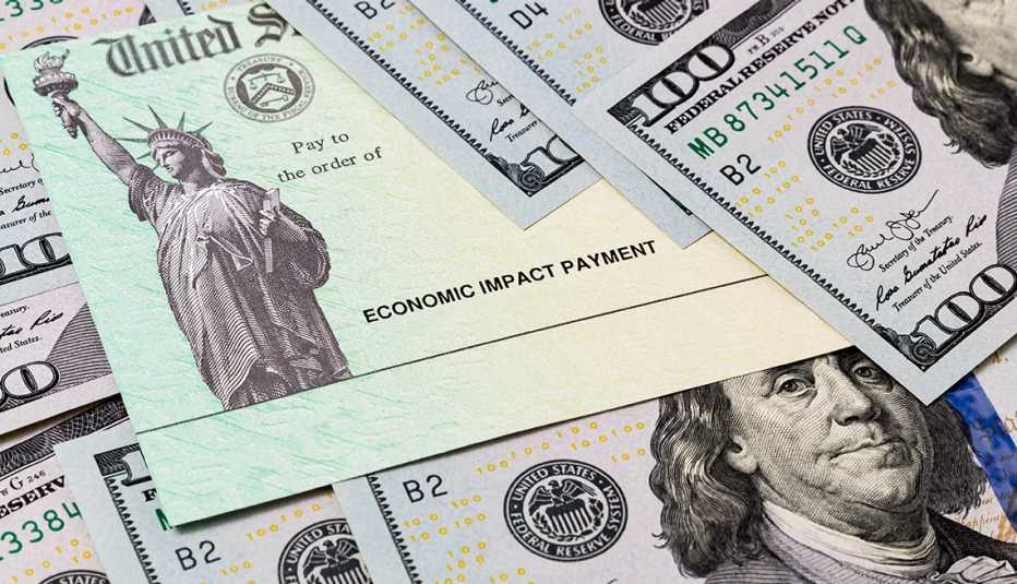A U.S. Treasury economic impact payment check can be seen in a display of hundred dollar bills  