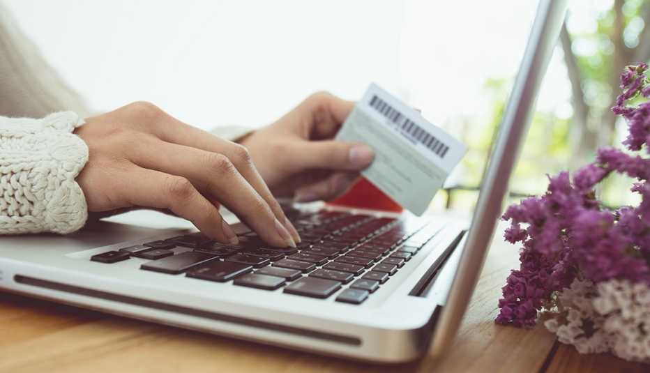 Close up of woman's hands with credit card online shopping