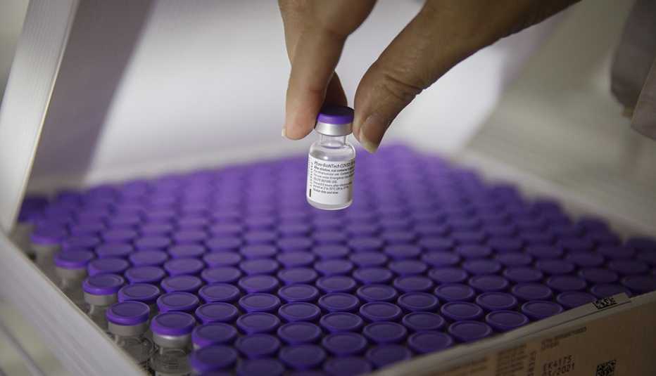 A nurse handles a vial of the the Pfizer-BioNTech Covid-19 vaccine, Kobi Wolf/Bloomberg via Getty Images