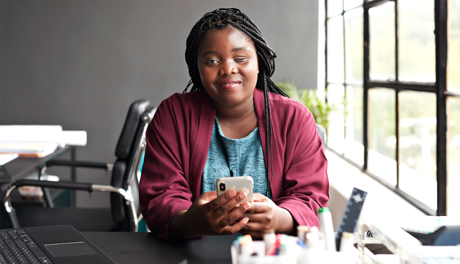 An entrepreneur with a disability using a phone in an office