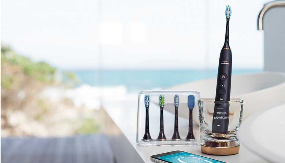 a black toothbrush with additional heads in front of blue water