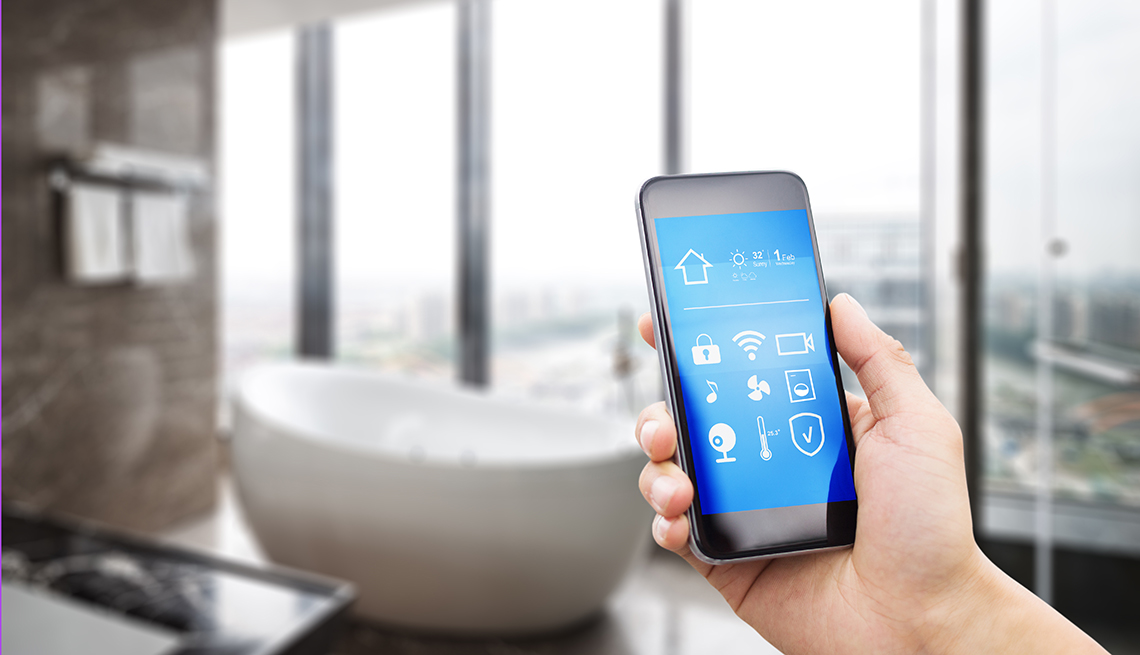 a person holds a mobile device up in front of a bathroom setting