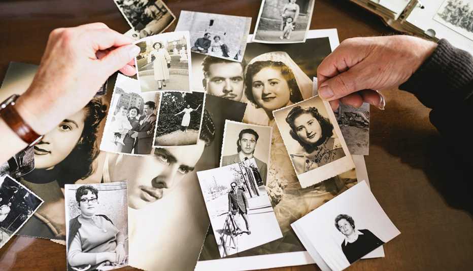 two hands holding old photographs