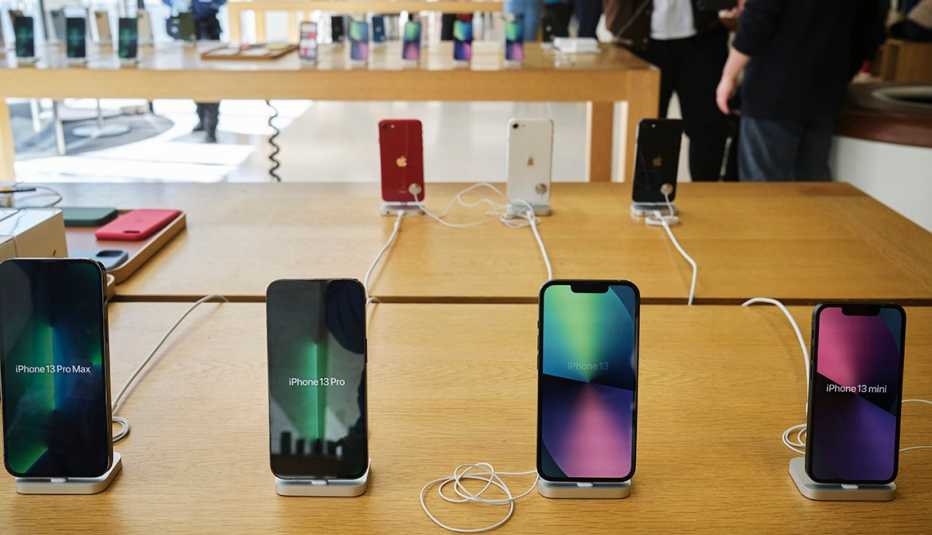 new iphone 13 devices on display on a wooden table