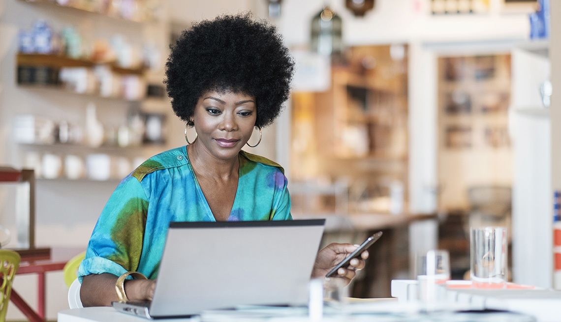 Business owner using laptop in store