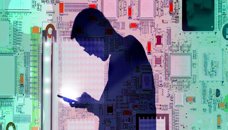 the silhouette of a man looking into a glowing smart phone the silhouette of a man looking into a glowing smart phone
