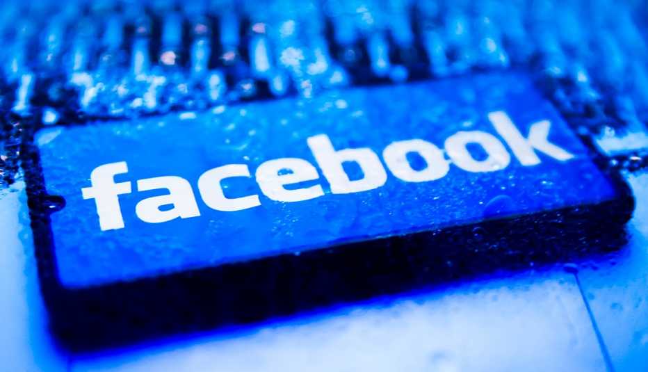 a white facebook logo on a blue mobile phone screen