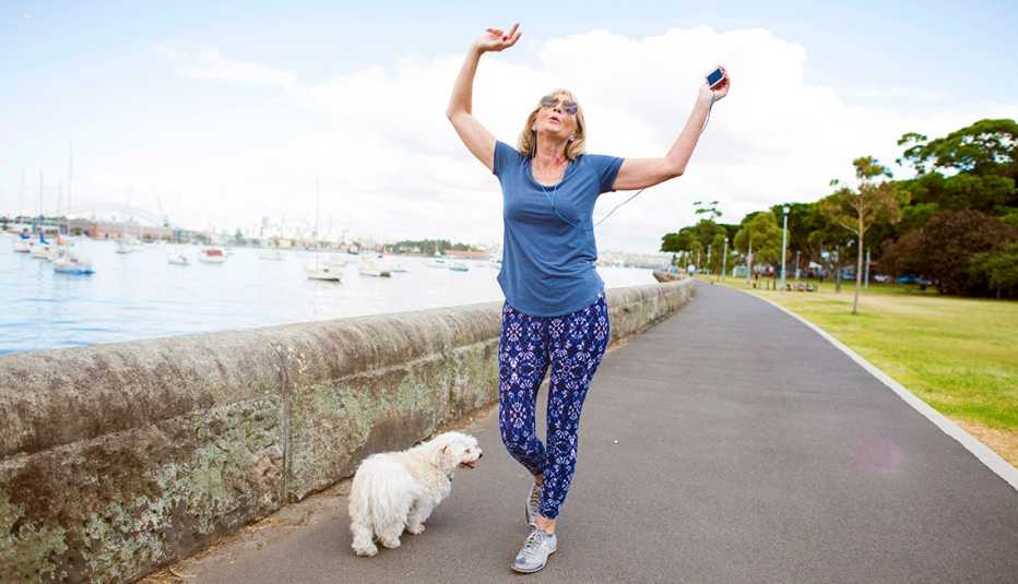 a woman in blue listens to music on her smartphone while she exercises