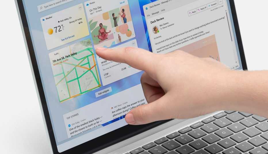 person using touchscreen on the microsoft surface laptop go two