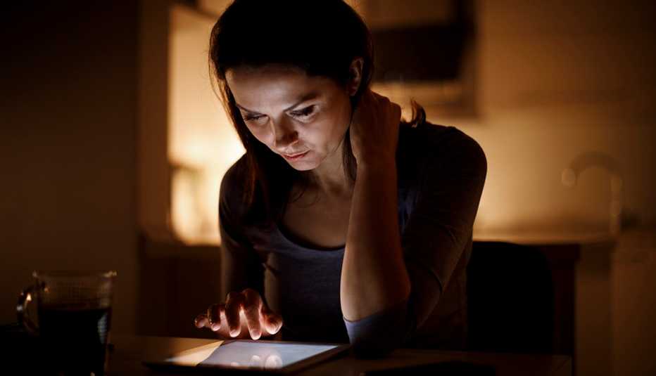 Woman using digital tablet at home
