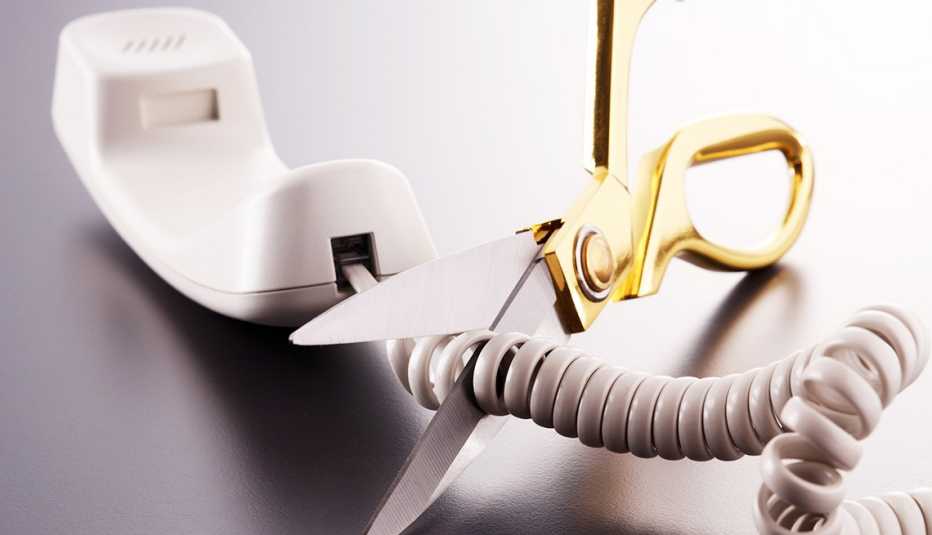 Scissors cut the cord of a wired phone Scissors cut the cord of a wired phone