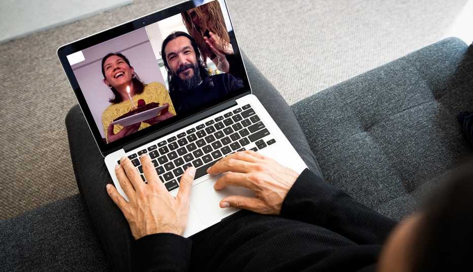 Blowing birthday candle.. Three friends making video conference. Celebrate your birthday while social distancing.