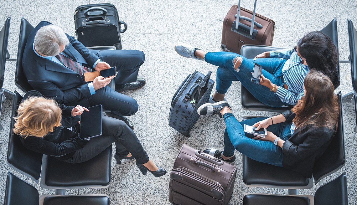 Travelers at airport on smart devices