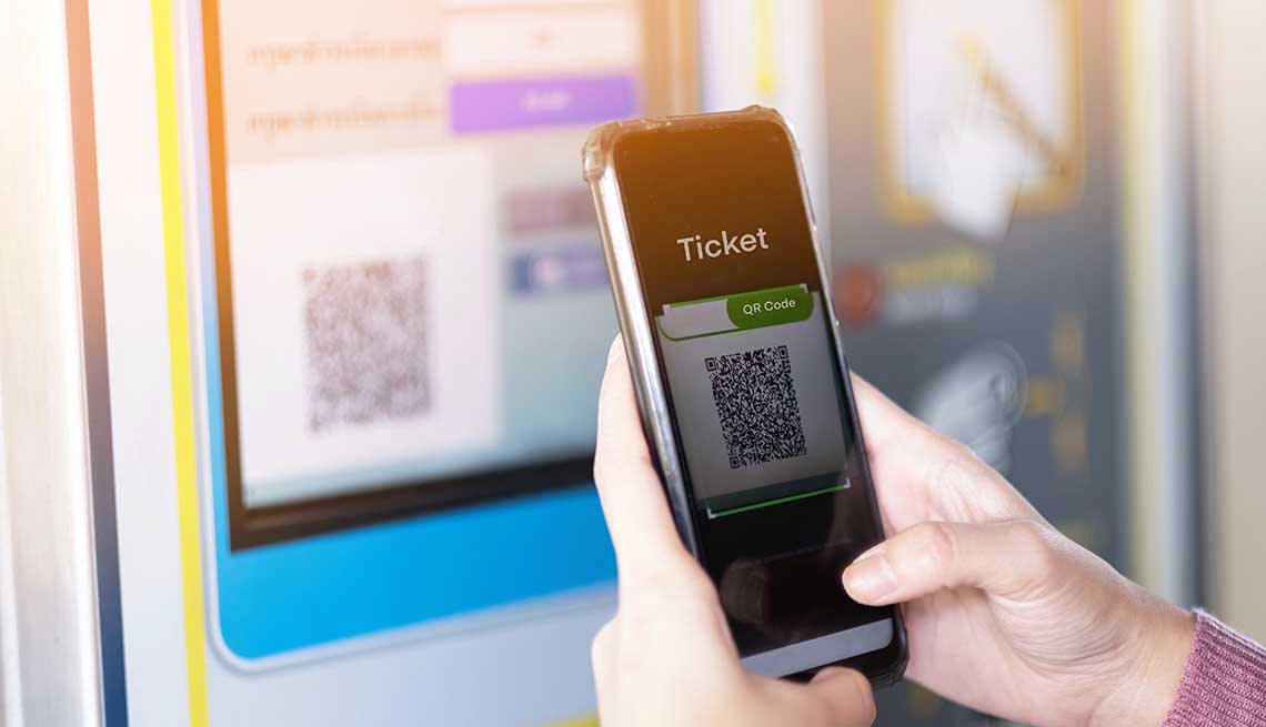 A girl scan QR code for buying the train ticket