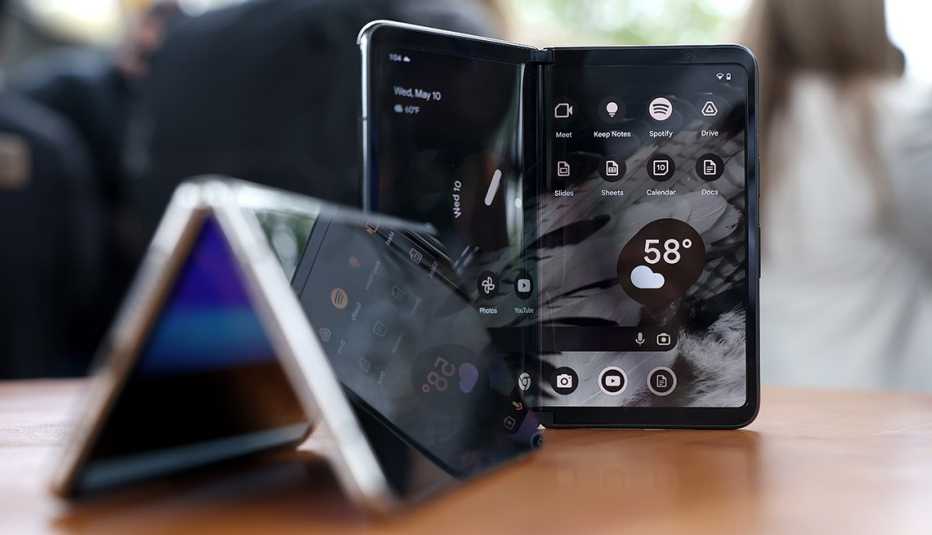 two black flip phones on display - one vertically and one horizontally