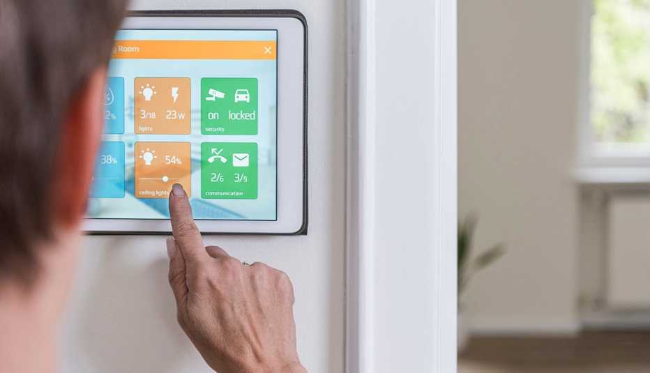 Woman changes ceiling lights on smart home device