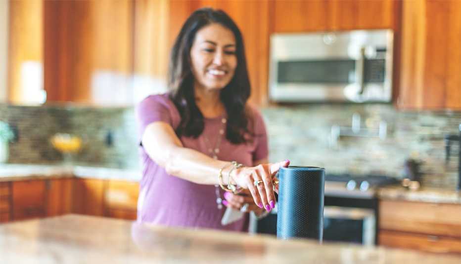 woman operating smart speaker devices in her home 