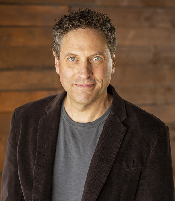 michael jamin in a gray t-shirt and brown blazer