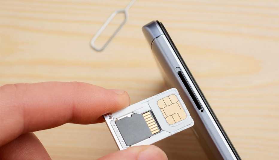 person expanding or upgrading memory in a mobile phone
