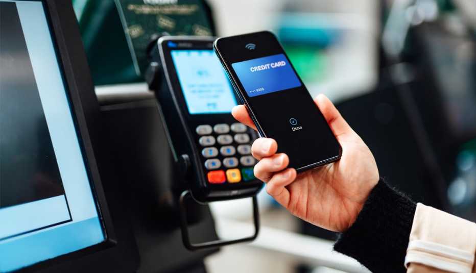 a person using credit card information on their phone to check out while shopping