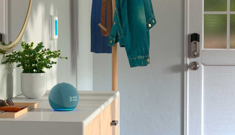 an amazon alexa device with a clock on it rests on a cupboard