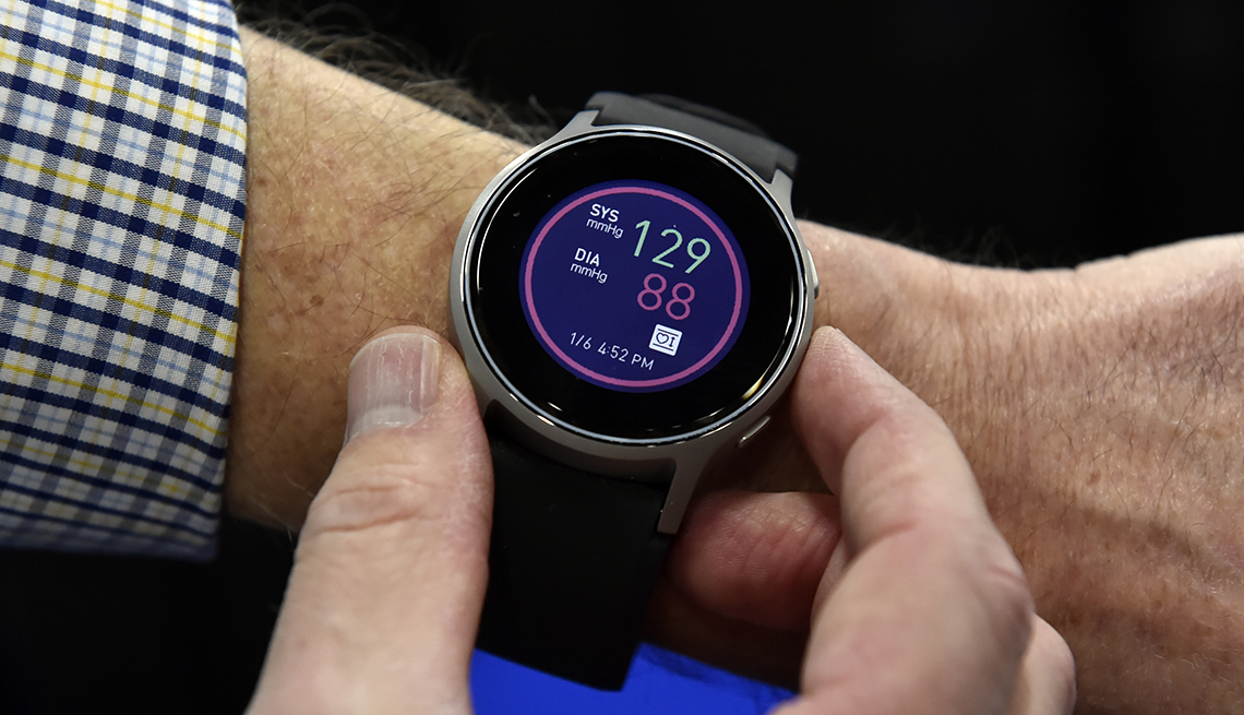 A man pressing buttons on his smartwatch