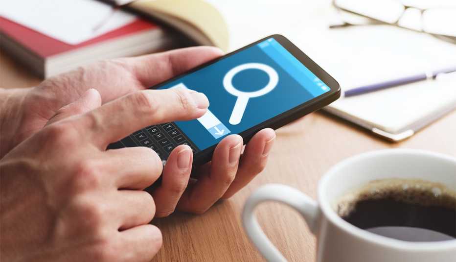 Magnifying glass icon on smartphone screen indicating an internet search