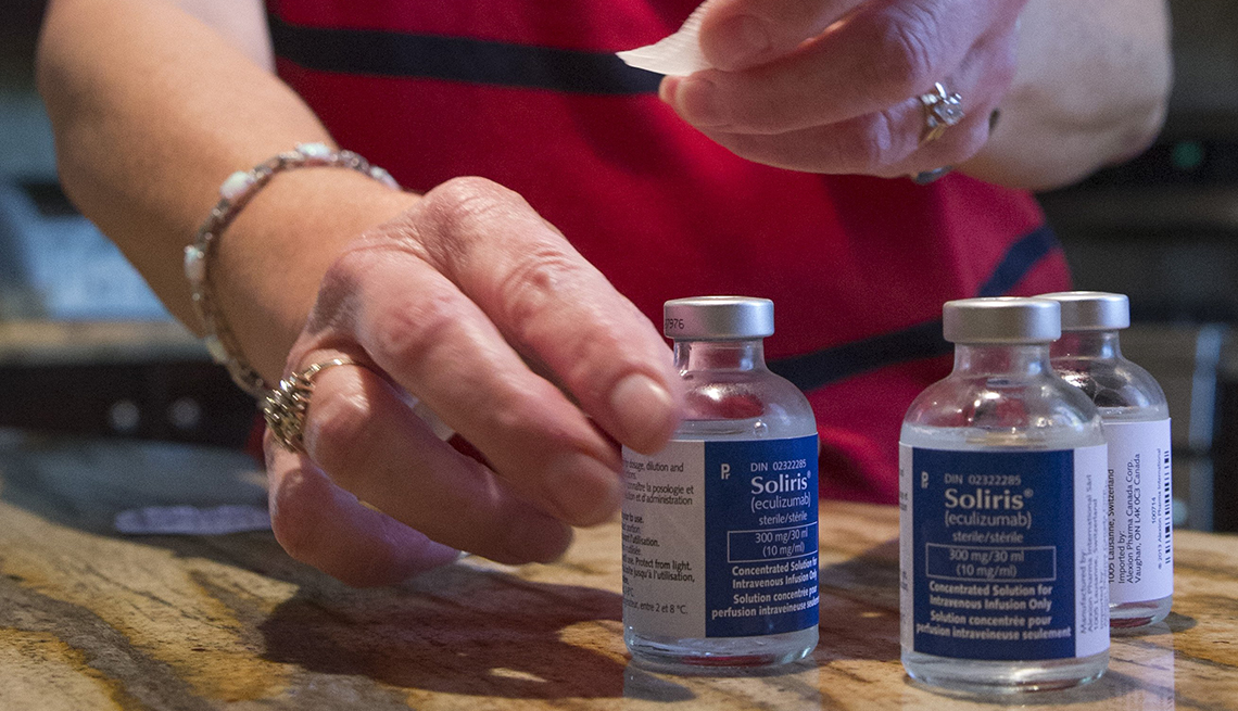 A nurse prepares vials of soliris