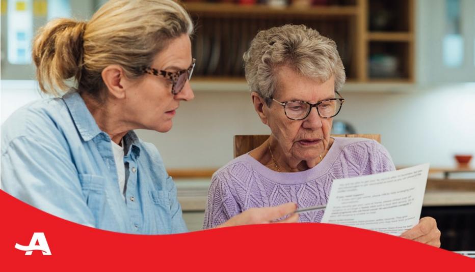 older woman with younger woman looking at a document together